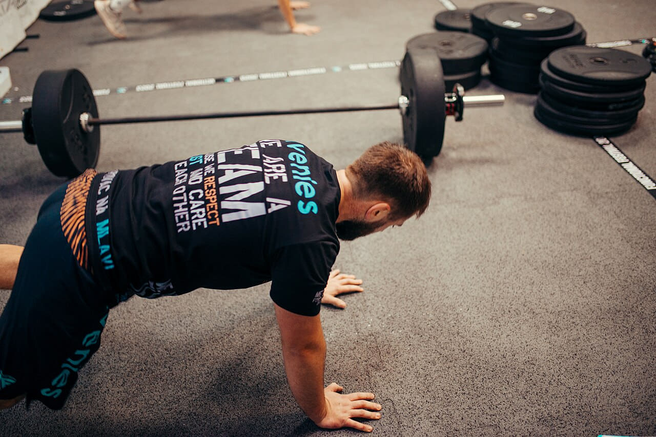 A dedicated individual engages in push-ups on a gym… wallpaper in sage green and sand tones, Full HD, 4:3 format for phone