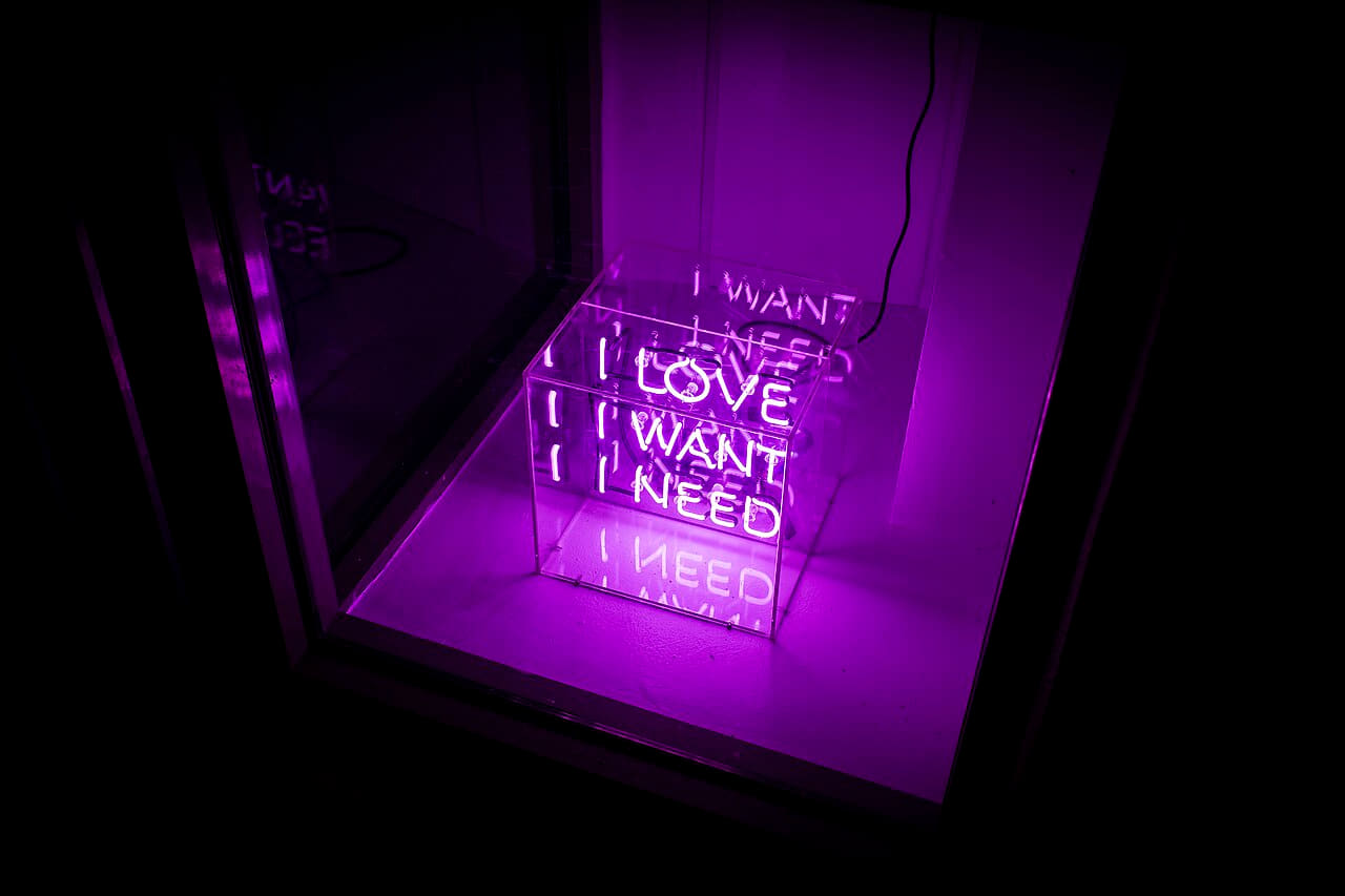 A neon lamp sculpture in a cube in a window. wallpaper in near-black and indigo tones, Full HD, 4:3 format for desktop