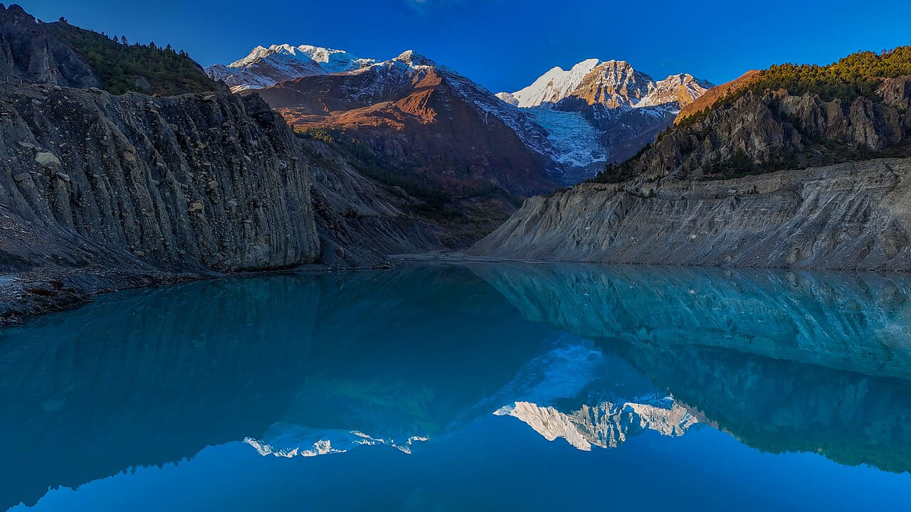 Morning Reflection at Gangapurna Lake wallpaper in deep green and charcoal tones, Full HD, 16:9 format for desktop