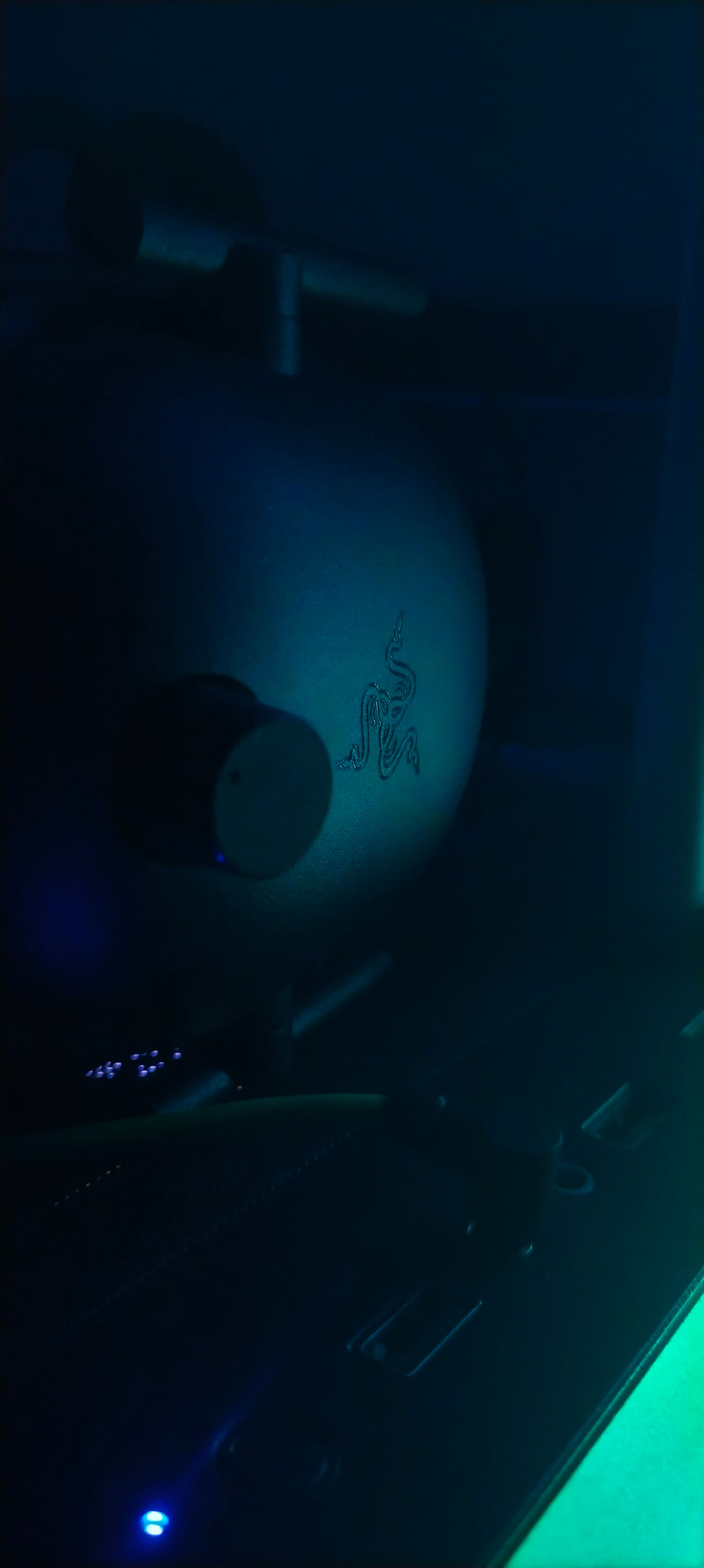 RGB gaming headset on desk with ambient lighting wallpaper in near-black and near-black tones, Full HD, 9:16 format for phone