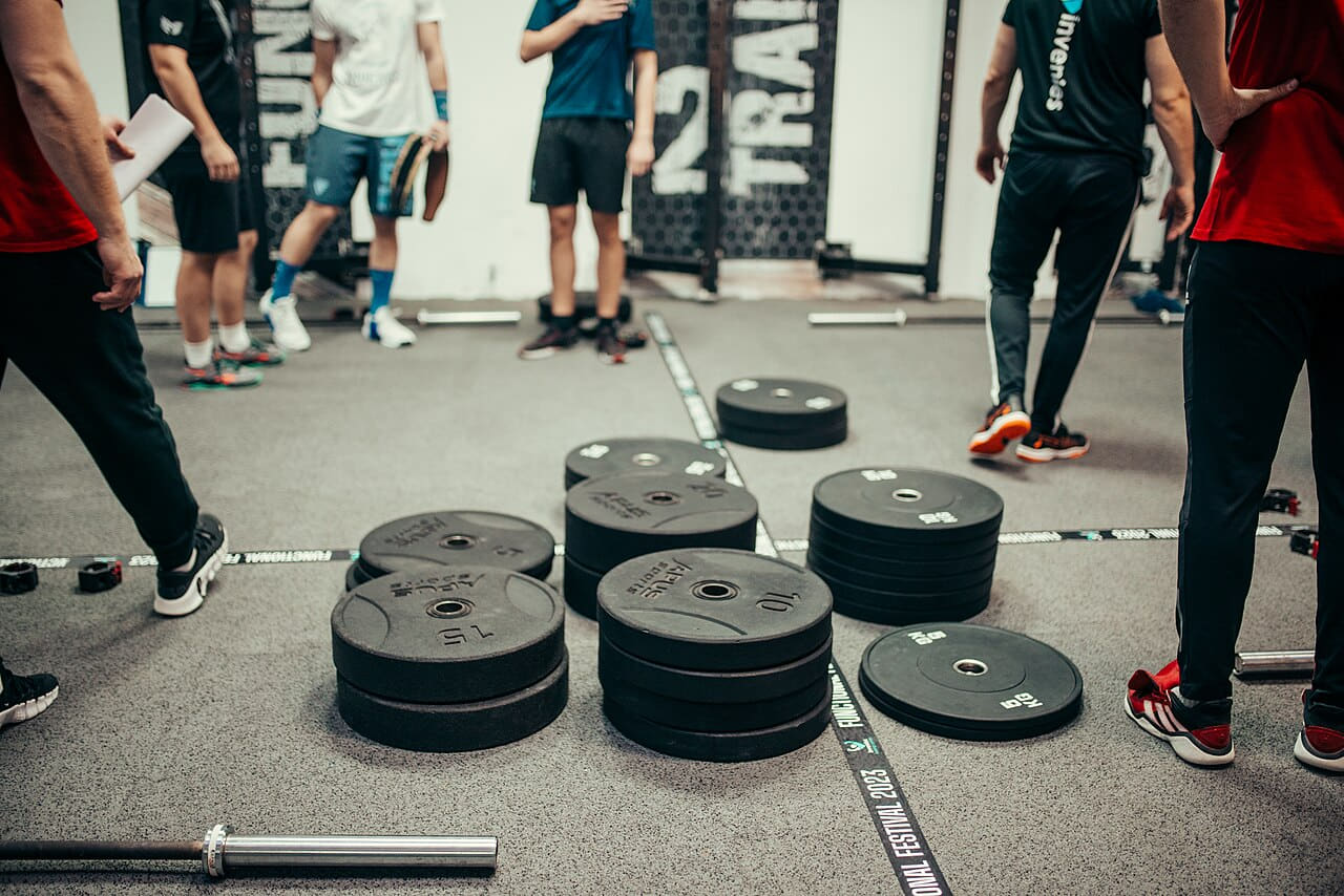 Several athletes and coaches gather in a gym for a… wallpaper in sage green and slate tones, Full HD, 4:3 format for phone