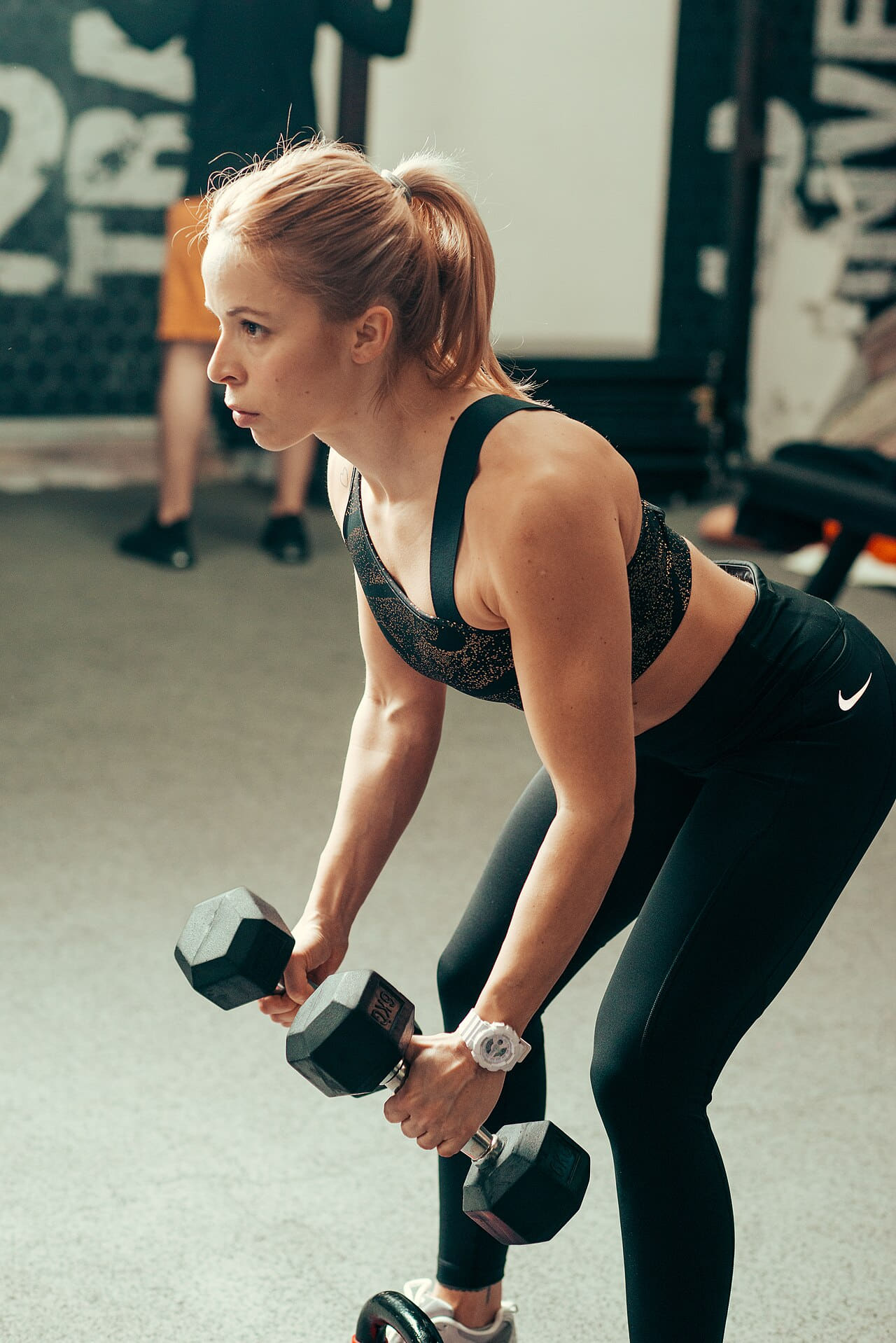 Woman lifting dumbbells in a modern gym during a… wallpaper in mint and near-black tones, Full HD, 3:4 format for phone